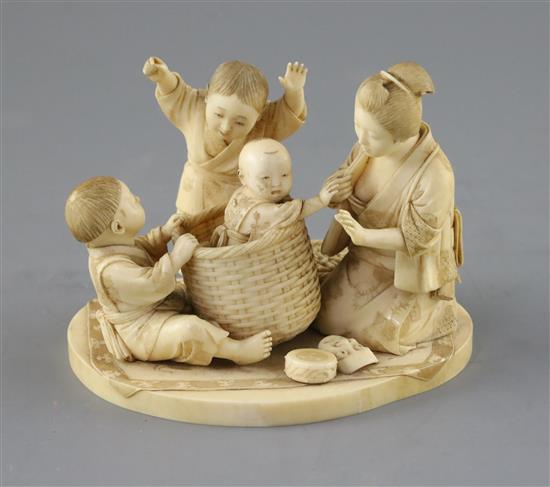 A good Japanese ivory okimono of a lady and children playing, Meiji period, H.9.5cm, W.12.2cm